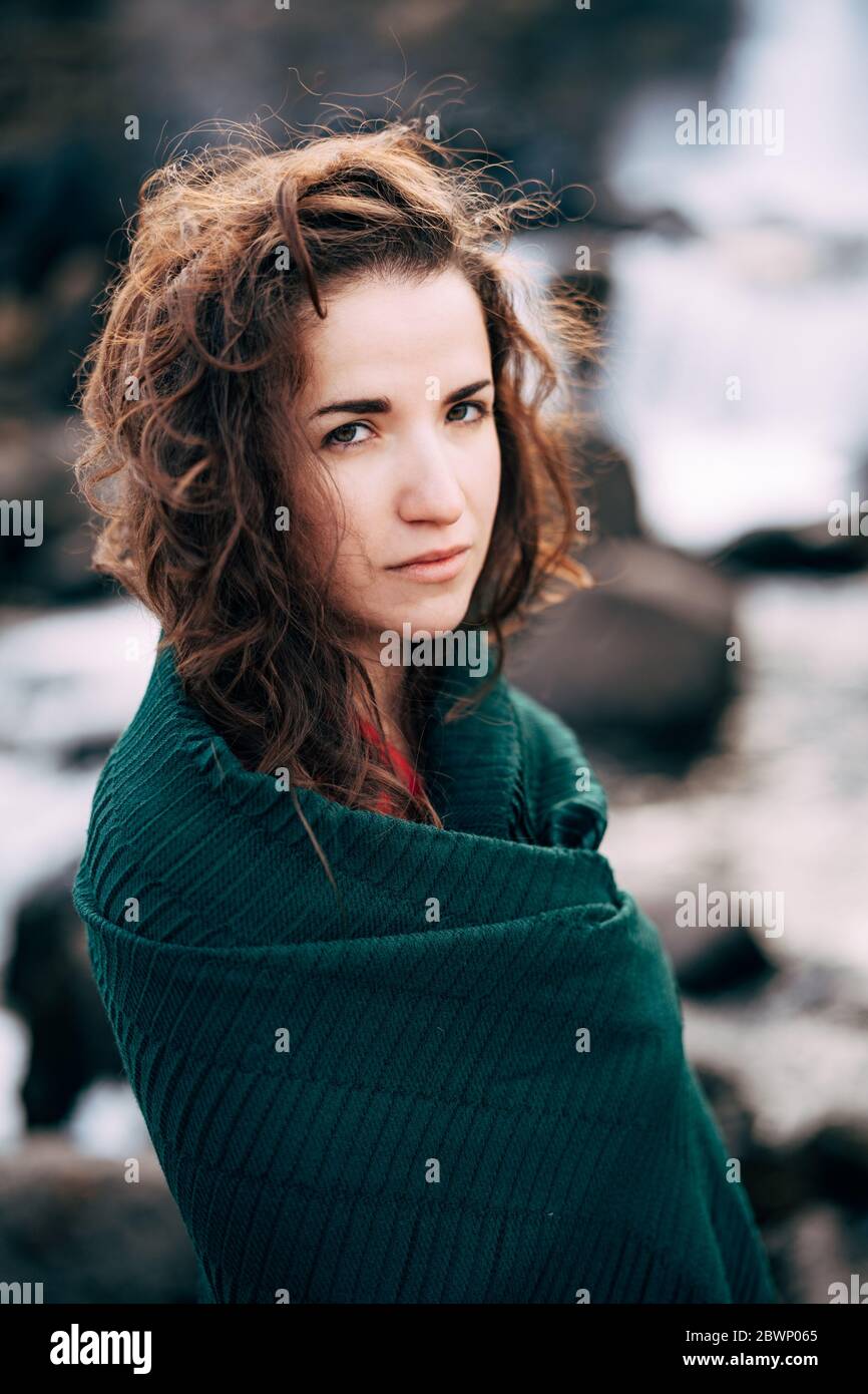 A girl in a red dress near Ehsaraurfoss Falls, Ehsarau River, National