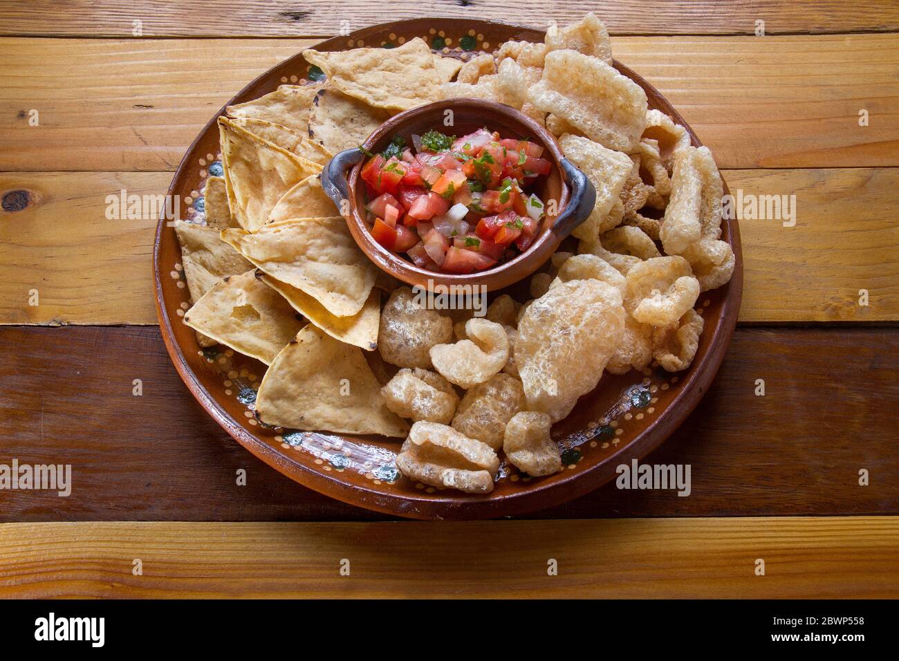 Authentic mexican pork rinds and tortilla chips with sauce Stock Photo