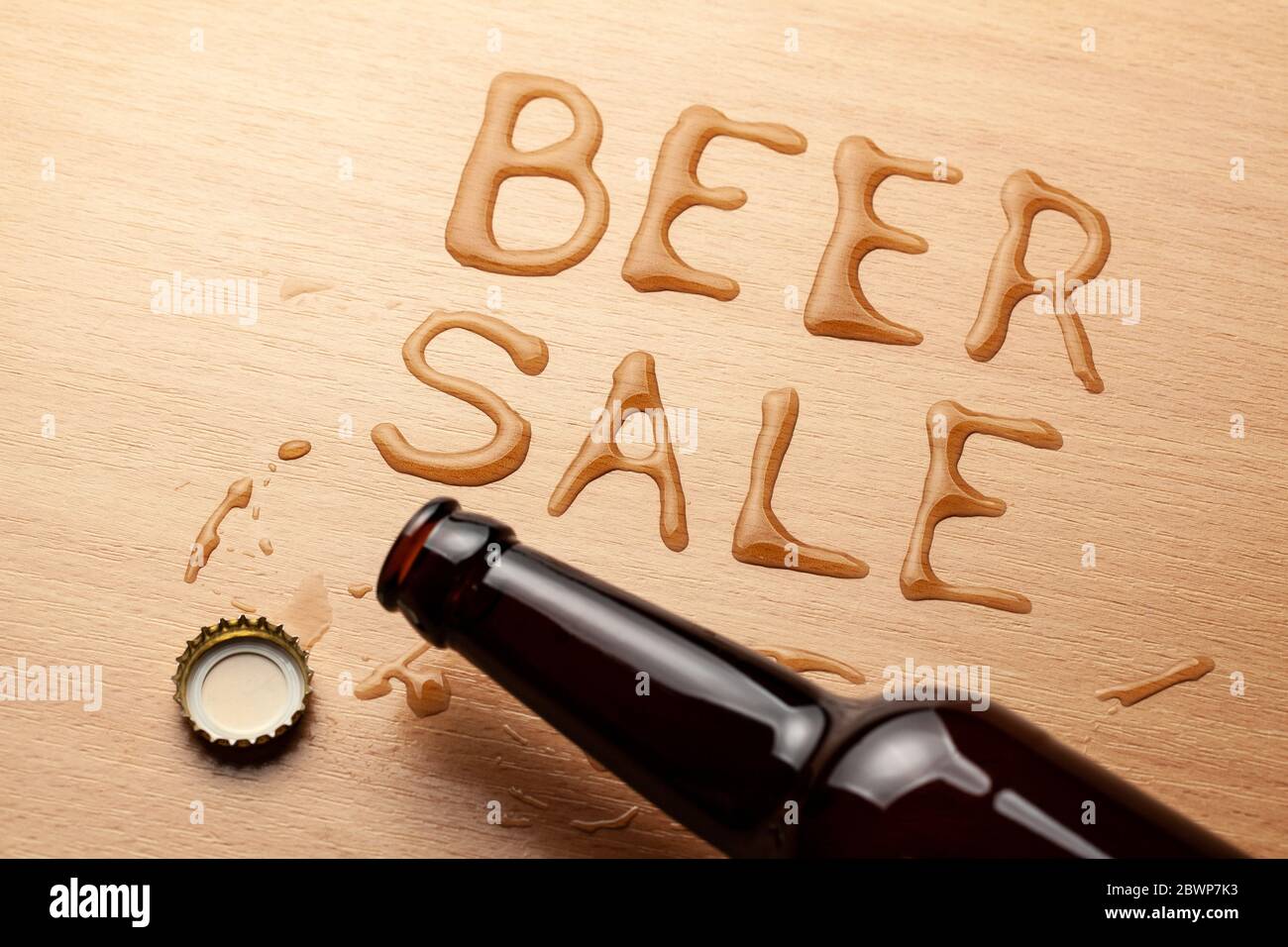 Beer For Sale. Beer bottle and spilled drink on the table Stock Photo