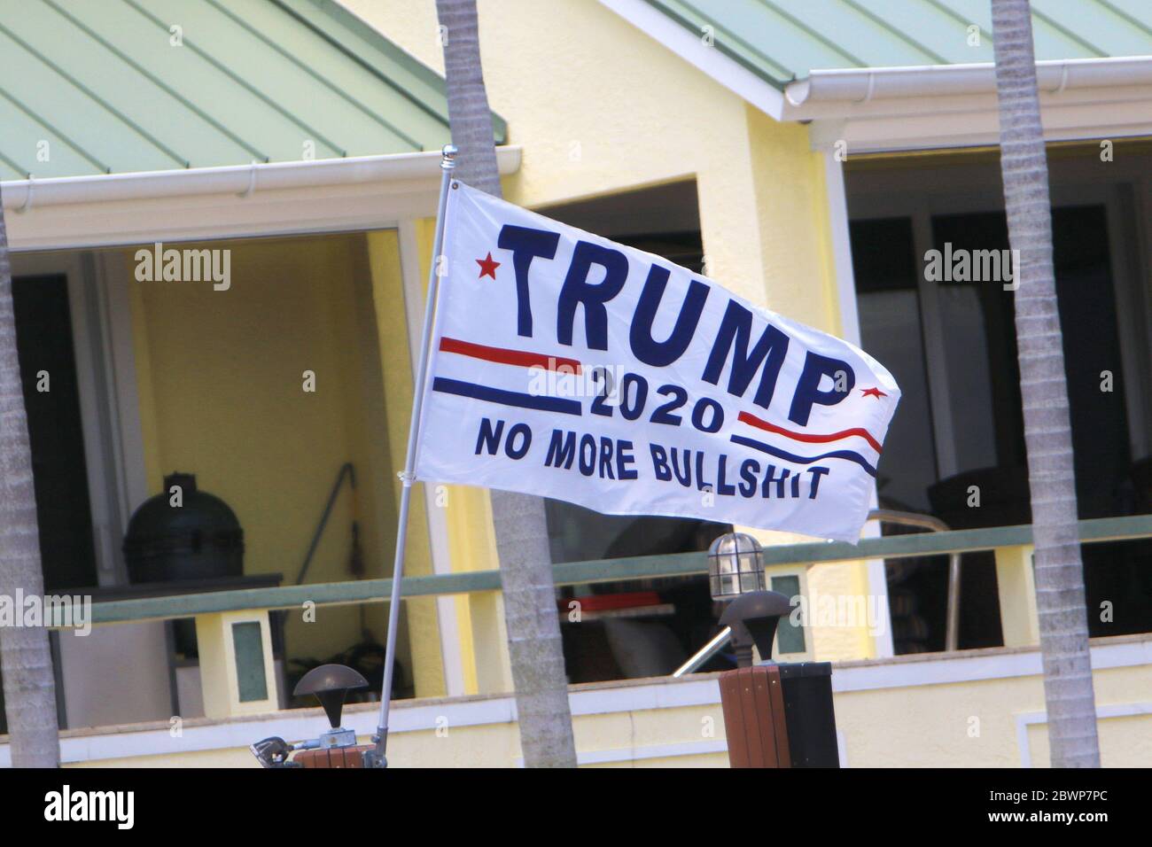 Marco Island, FL, 5/23/2020: 'Trump. No more bullshit' banner is flying on a post at a private residence. Stock Photo