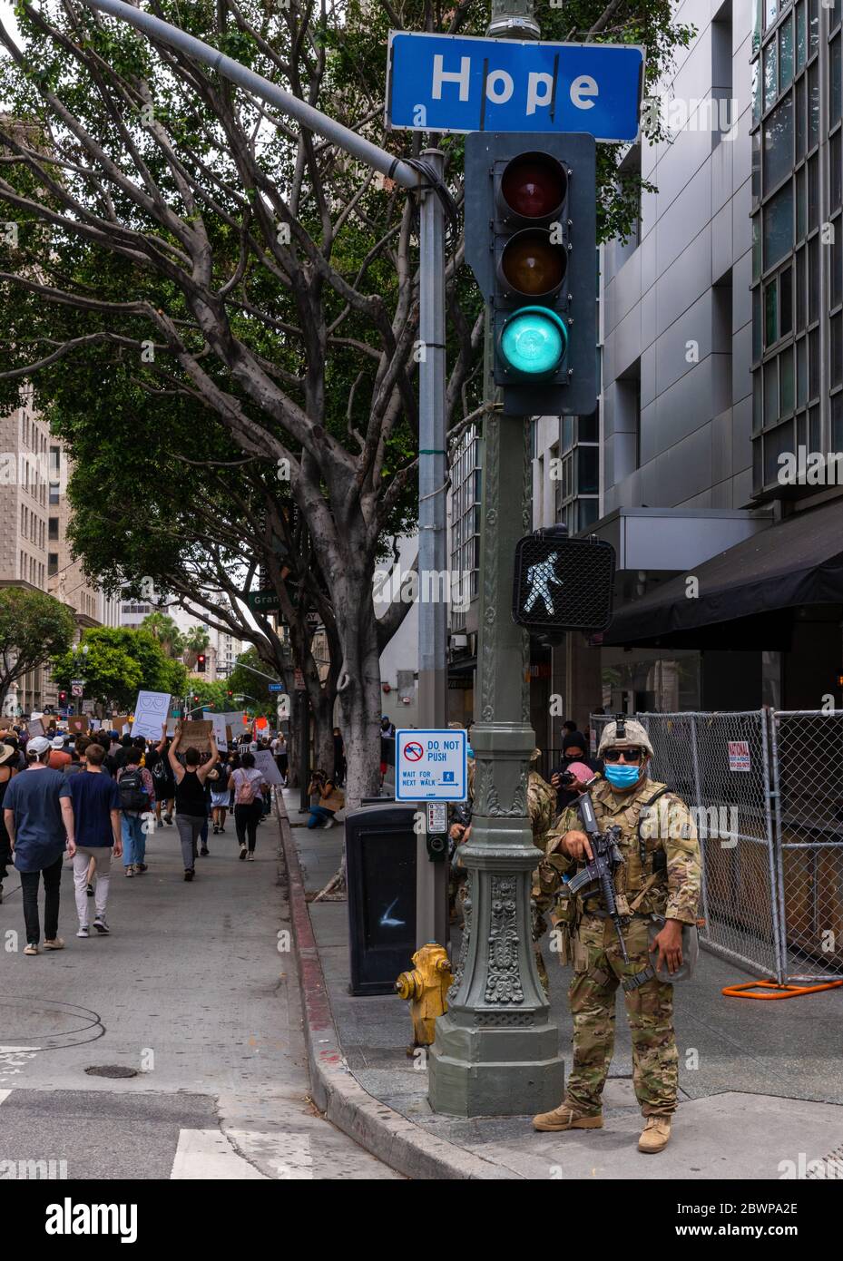 Los Angeles, USA, 3rd June, 2020. Protesters march by National Guard soldier at intersection of Hope and 6th St . Credit: Jim Newberry/Alamy Live News. Stock Photo