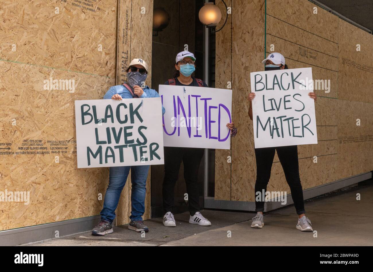 Los Angeles, USA, 3rd June, 2020. Protesters with Black Lives Matter signs in front of boarded up building Downtown. Credit: Jim Newberry/Alamy Live News. Stock Photo