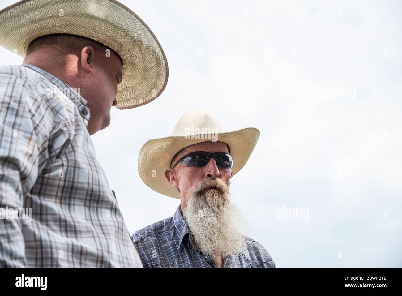 Two Cowboys Talking Stock Photo