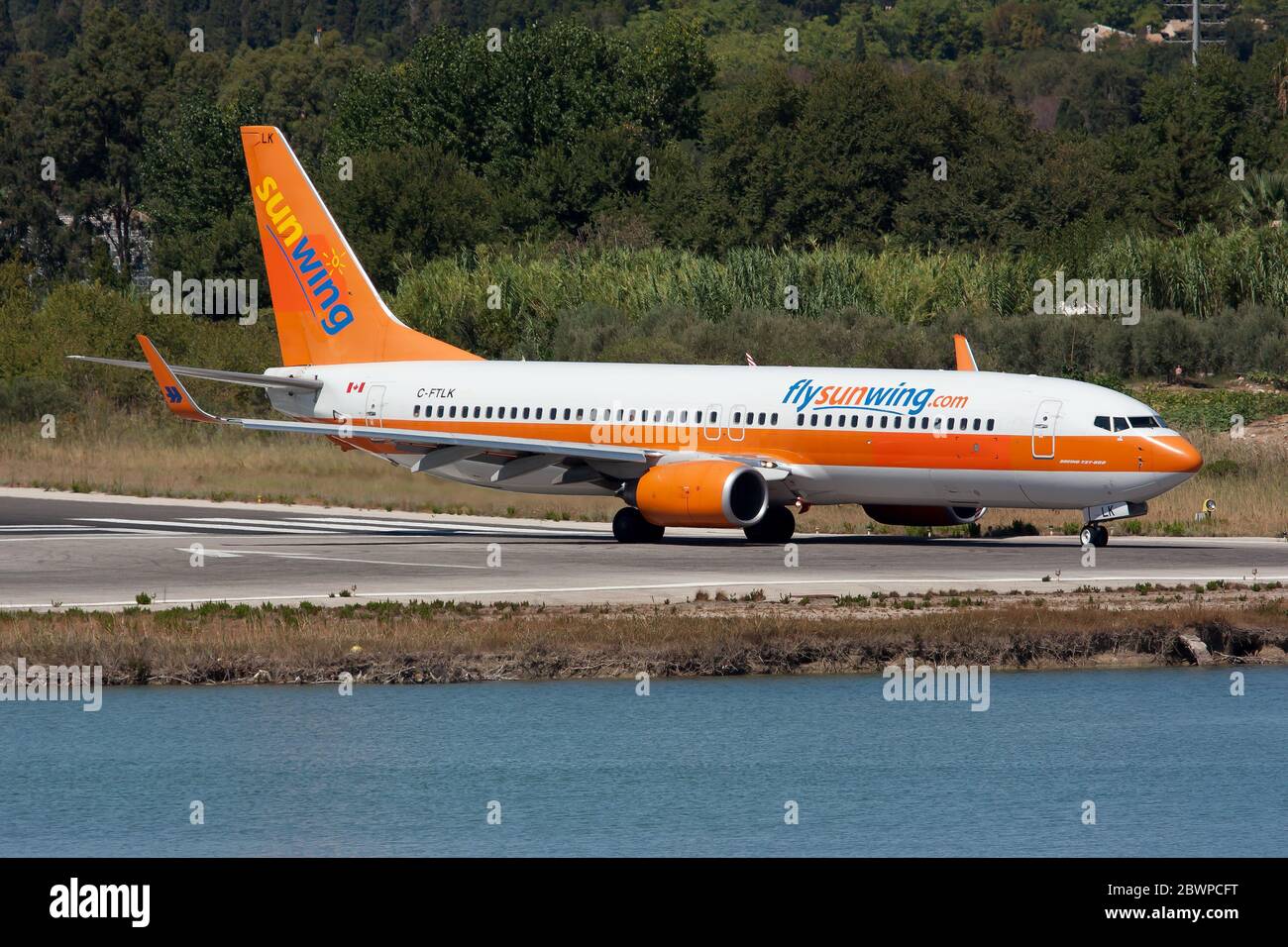 A Sunwing Airlines Boeing 737-800 in Hapag-Lloyd colours preparing to depart  from Corfu airport. Stock Photo