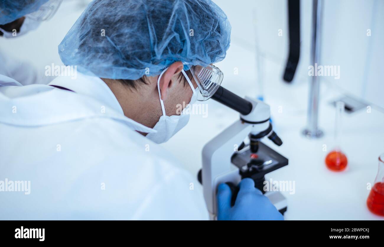 close up. scientist looking through a microscope. Stock Photo