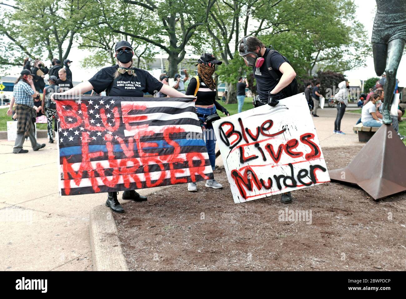 Protesters in Cleveland, Ohio, USA hold signs stating Blue Lives Murder during protests against the murder of George Floyd in the hands of police. Stock Photo