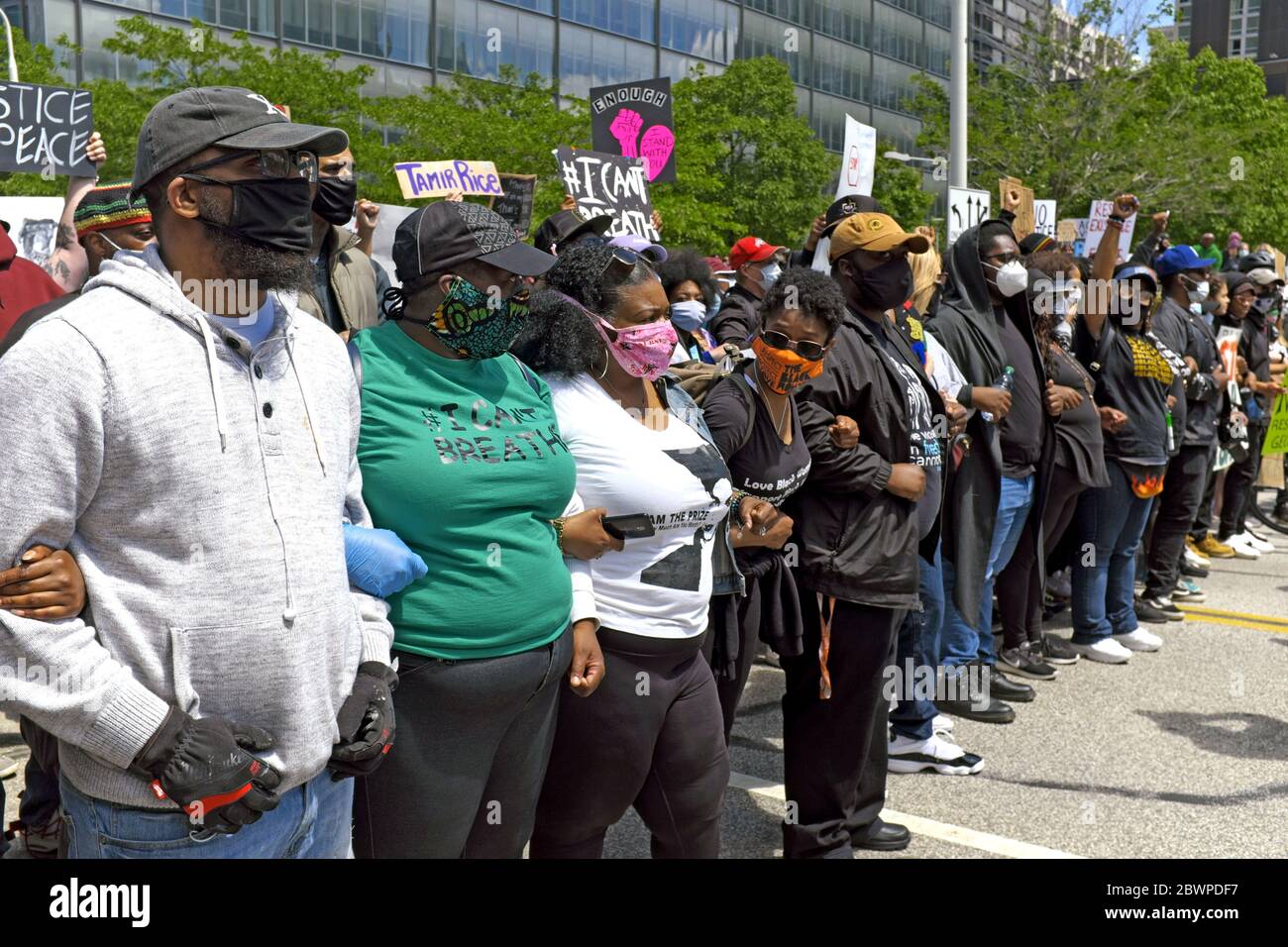 Protesters with arms linked and signs raised line-up for a protest march in downtown Cleveland, Ohio, USA against police brutality of blacks. Stock Photo
