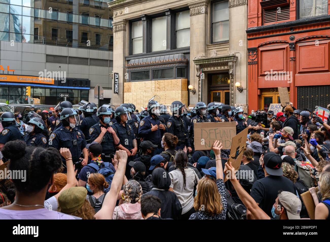 Protestors and police in a march for George Floyd in lower Manhattan on 6/2/2020. Many of the protestors had taken a knee and were chanting for the police to do the same. Stock Photo