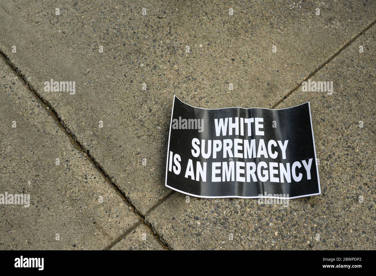 A discarded sign reading 'white Supremacy is an emergency' at a protest for George Floyd in lower Manhattan 6/2/2020 Stock Photo