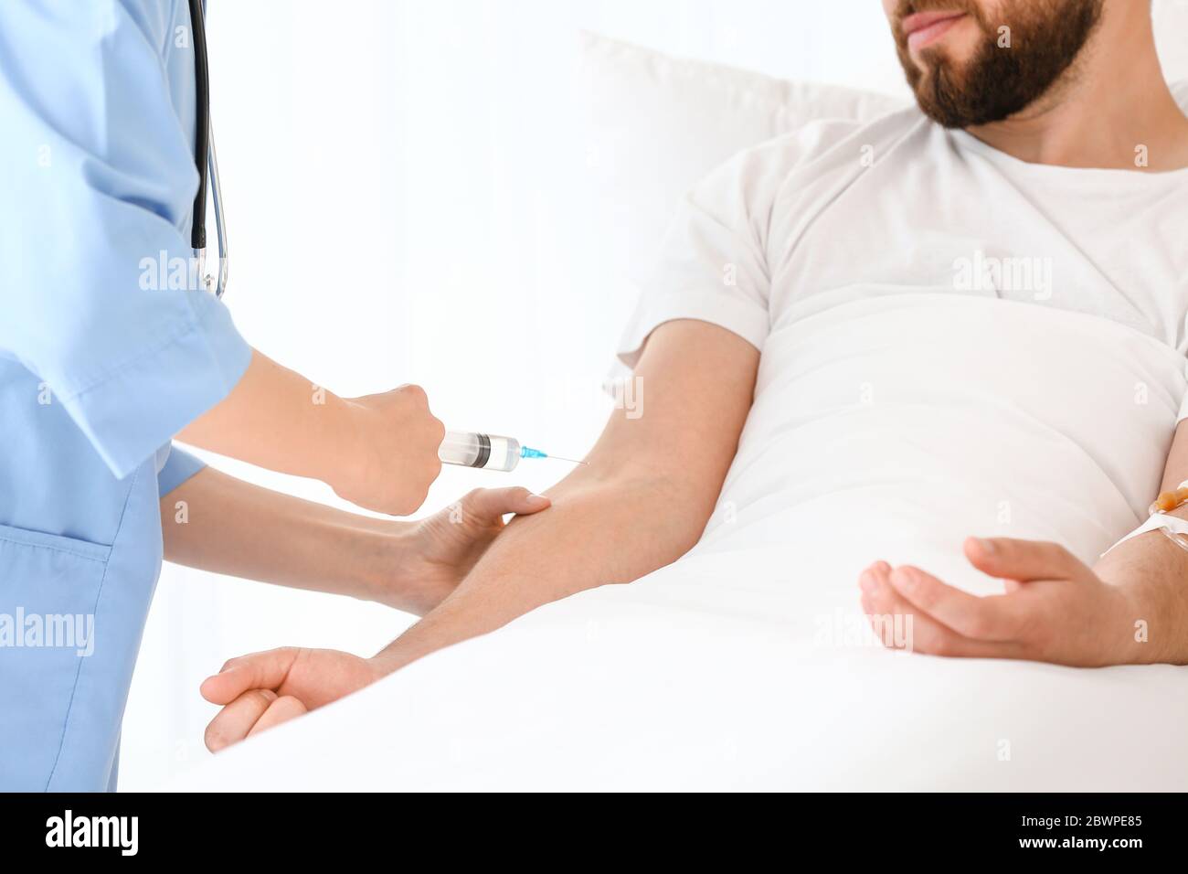 Female doctor working with patient in hospital room Stock Photo - Alamy