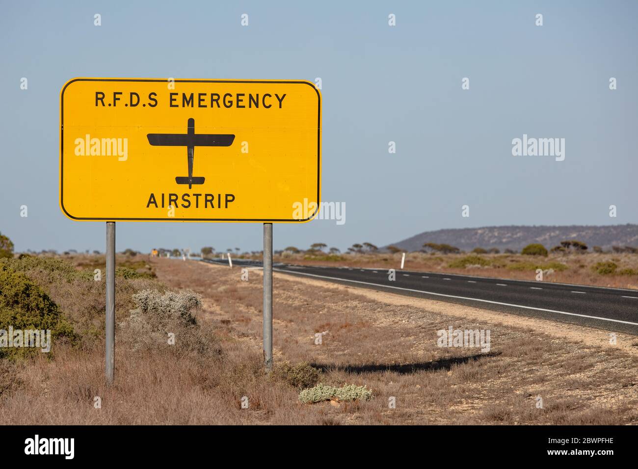 Royal Flying Doctor Emergency Service sign denoting the road may also be used as a landing strip in a medical emergency. Captured in Western Australia Stock Photo