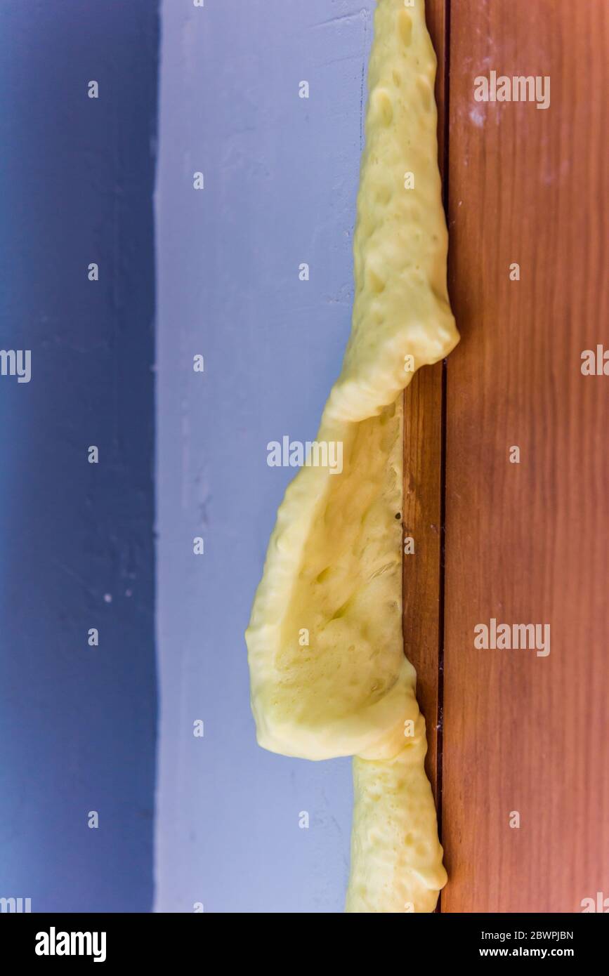 Insulating expanding foam sealant that has expanded from a door frame