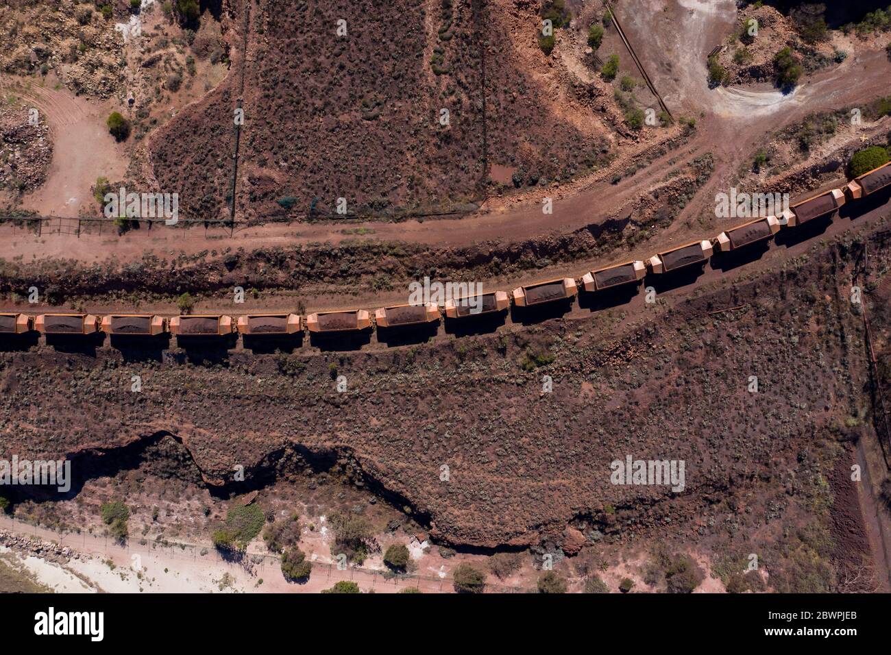 Overhead view of industrial railway cars loaded with iron ore ready for transportation, captured at Whyalla in South Australia Stock Photo