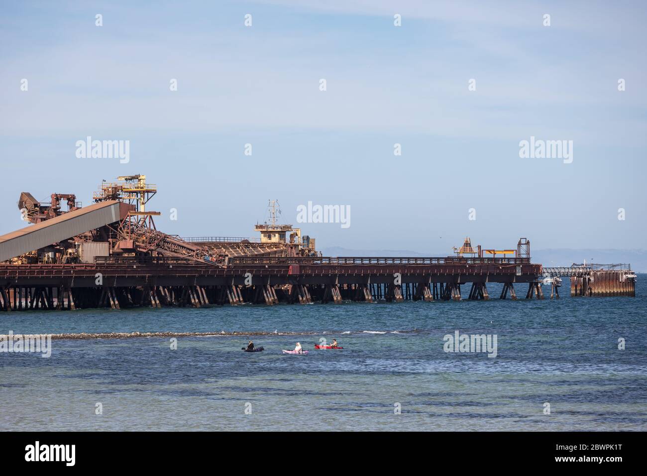 Whyalla South Australia November 17th 2019 : Fishing from a kayak in front of the steelworks jetty at Whyalla port in South Australia Stock Photo