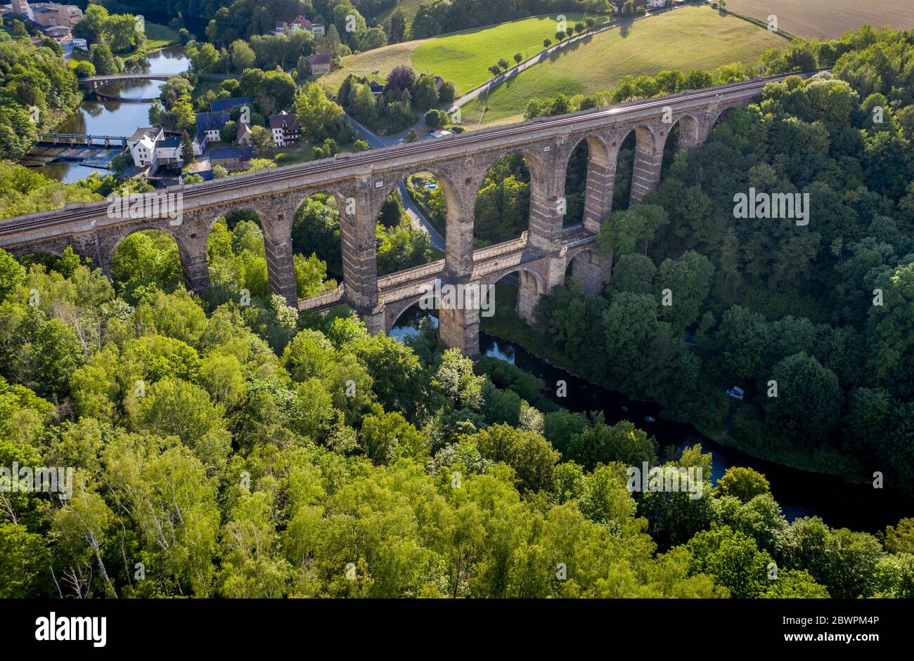 14 September 2017, Saxony, Göhren: With the Göhren Viaduct, the Leipzig-Chemnitz railway line crosses the Zwickauer Mulde. The railway bridge, originally 512 metres long and 68 metres high, is the third largest of these structures in Saxony. For years, only regional trains have been running on the only slightly electrified line between Leipzig and Chemnitz. The planned expansion of the line will not begin until 2025 at the earliest. If conditions are favourable, the line could be double-tracked and electric power could be available three years later. (Aerial photograph with drone) Photo: Jan W Stock Photo