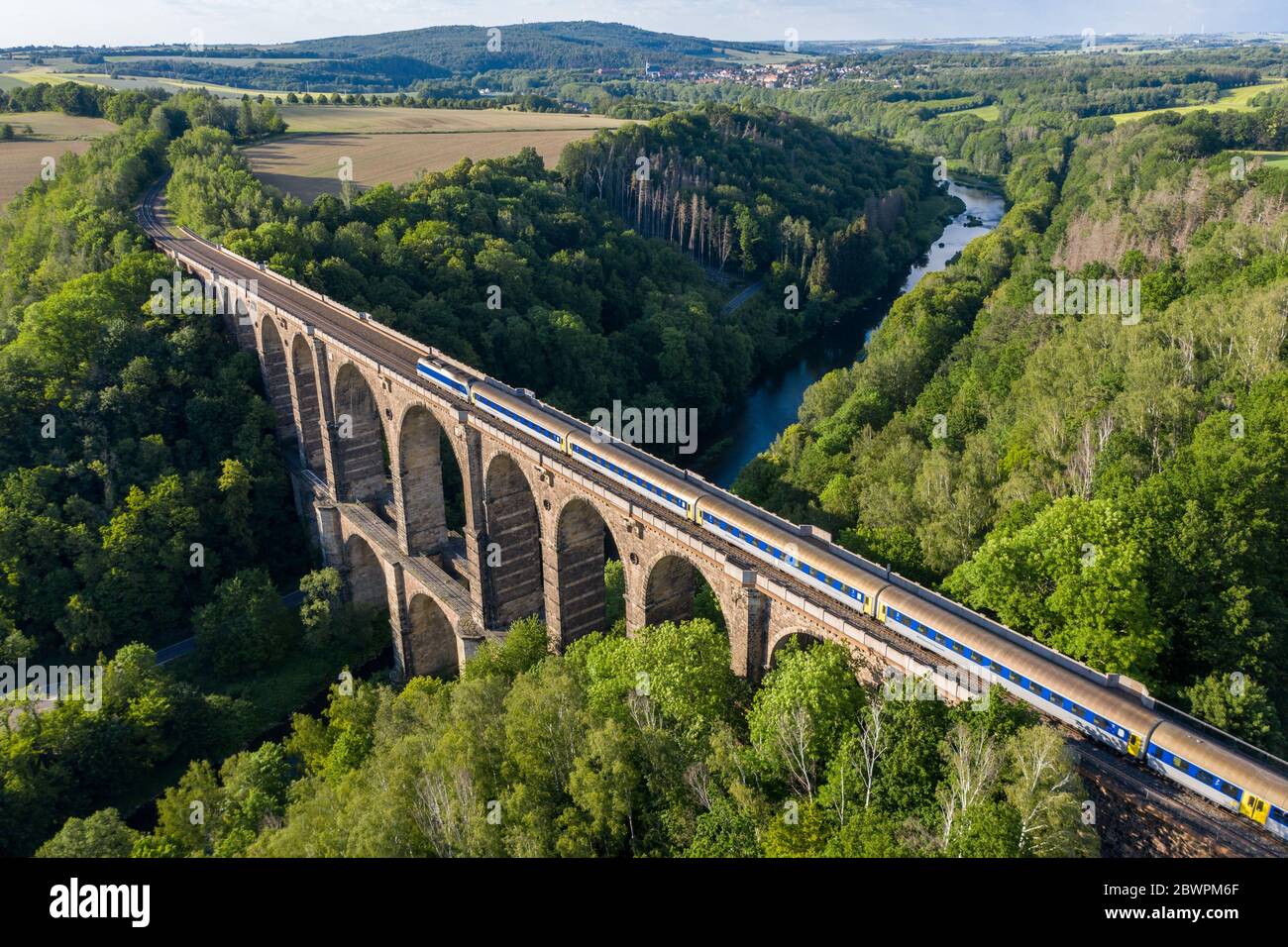 14 September 2017, Saxony, Göhren: A train of the Mitteldeutsche Regiobahn (MRB) crosses the Zwickauer Mulde on the Göhren viaduct. The railway bridge, originally 512 meters long and 68 meters high, is the third largest of these structures in Saxony. For years only regional trains have been running on the only slightly electrified line between Leipzig and Chemnitz. The planned expansion of the line will not begin until 2025 at the earliest. If conditions are favourable, the line could be double-tracked and electric power could be available three years later. (Aerial photograph with drone) Phot Stock Photo