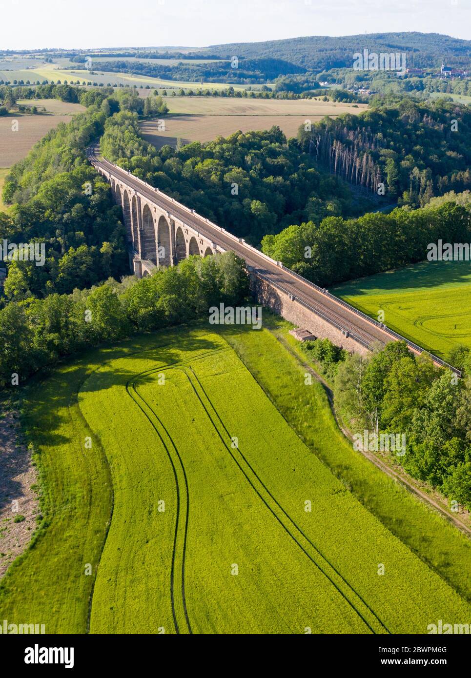 14 September 2017, Saxony, Göhren: With the Göhren Viaduct, the Leipzig-Chemnitz railway line crosses the Zwickauer Mulde. The railway bridge, originally 512 metres long and 68 metres high, is the third largest of these structures in Saxony. For years, only regional trains have been running on the only slightly electrified line between Leipzig and Chemnitz. The planned extension of the line will not begin until 2025 at the earliest. If conditions are favourable, the line could be double-tracked and electrified three years later. (Aerial photograph with drone) Photo: Jan Woitas/dpa-Zentralbild/ Stock Photo