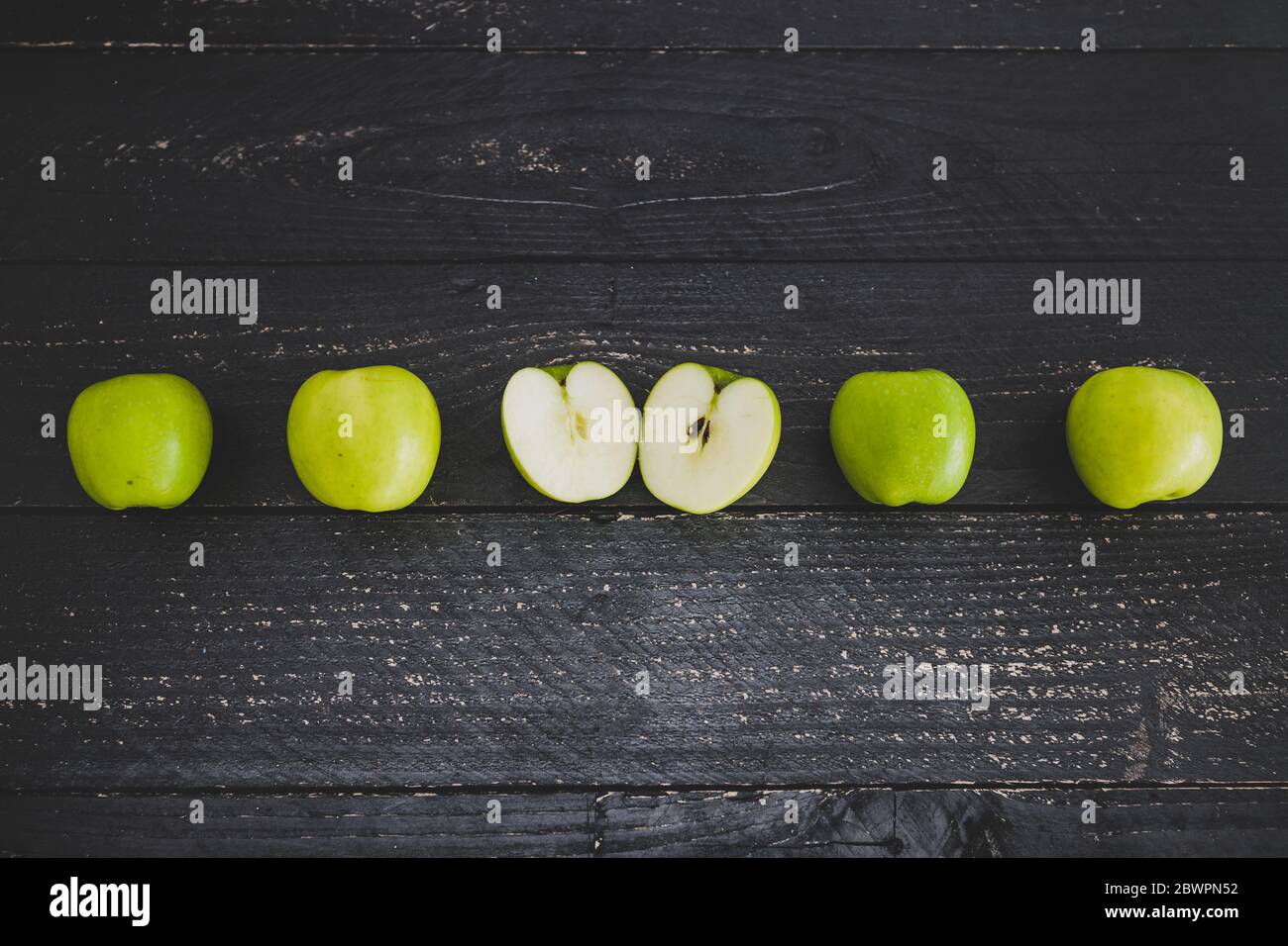 healthy-plant-based-food-ingredients-concept-green-apples-lined-up-on