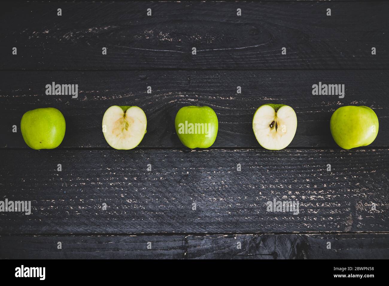 healthy-plant-based-food-ingredients-concept-green-apples-ined-up-on