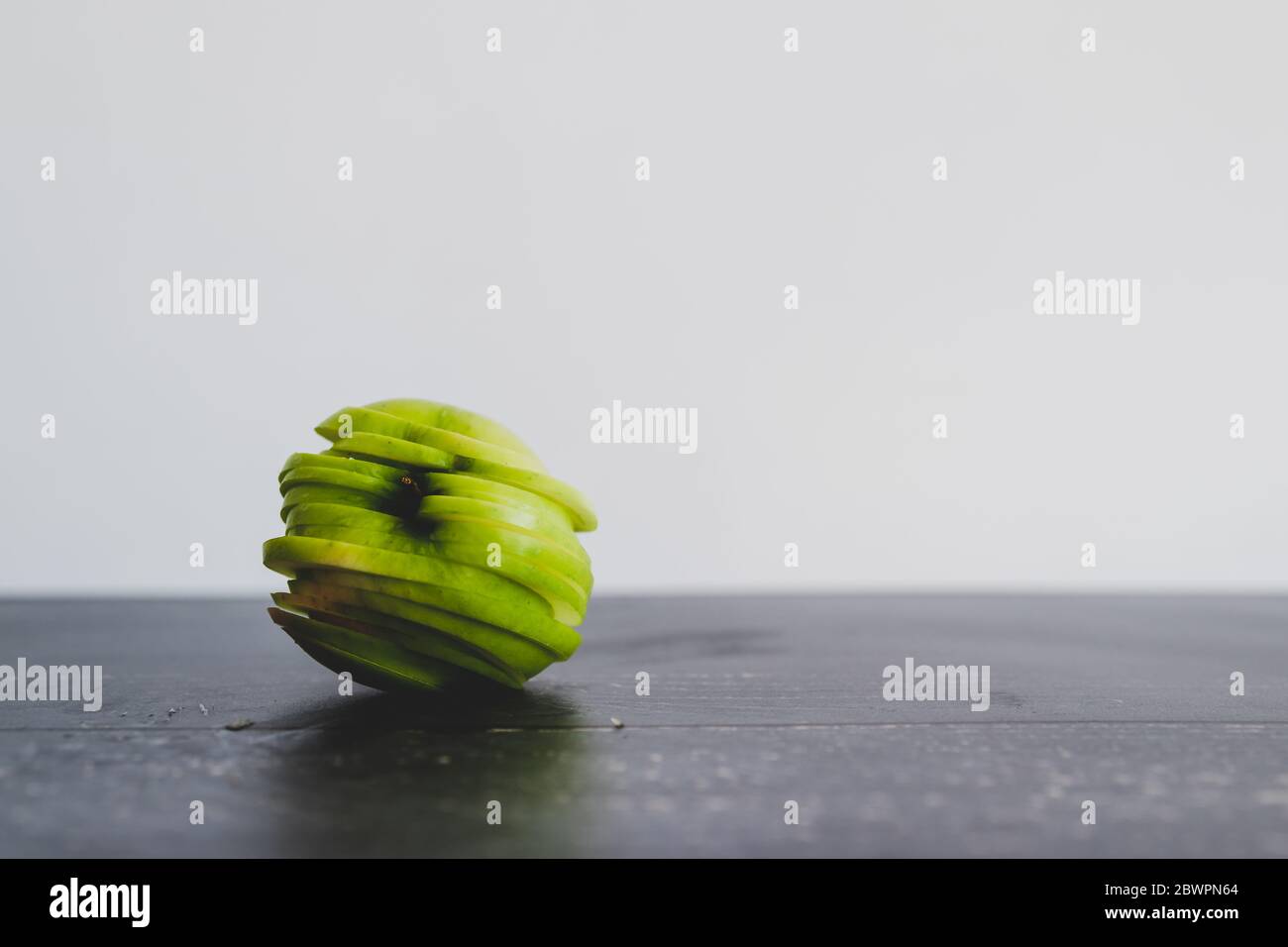 healthy-plant-based-food-ingredients-concept-green-apple-cut-into-thin