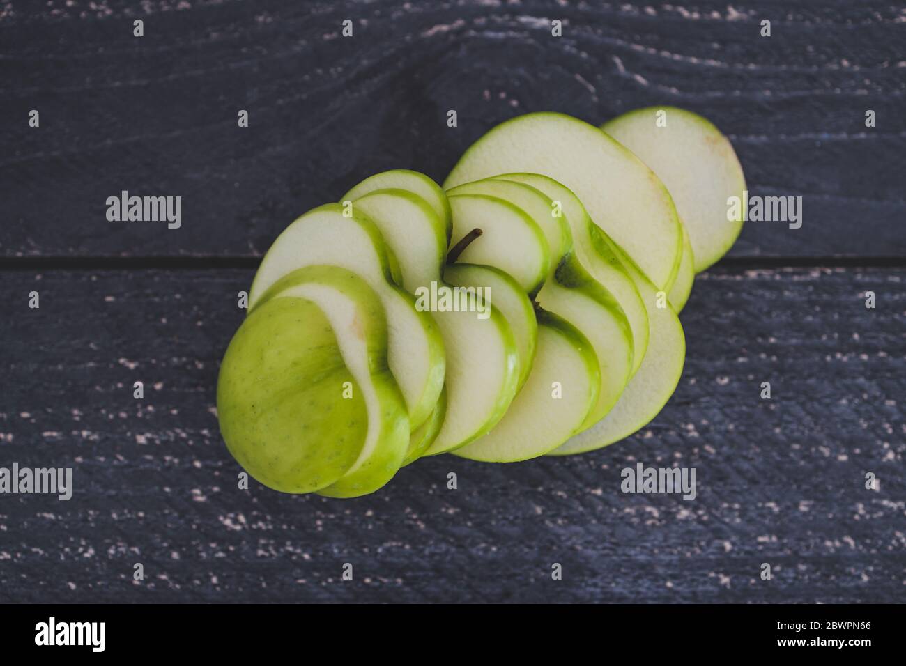 healthy-plant-based-food-ingredients-concept-green-apple-cut-into-thin