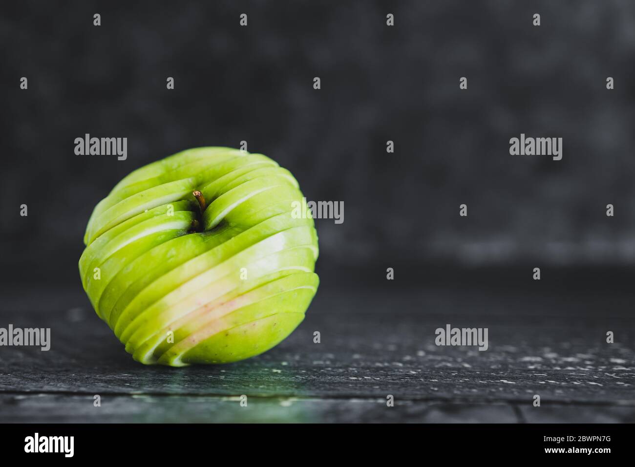 healthy-plant-based-food-ingredients-concept-green-apple-cut-into-thin