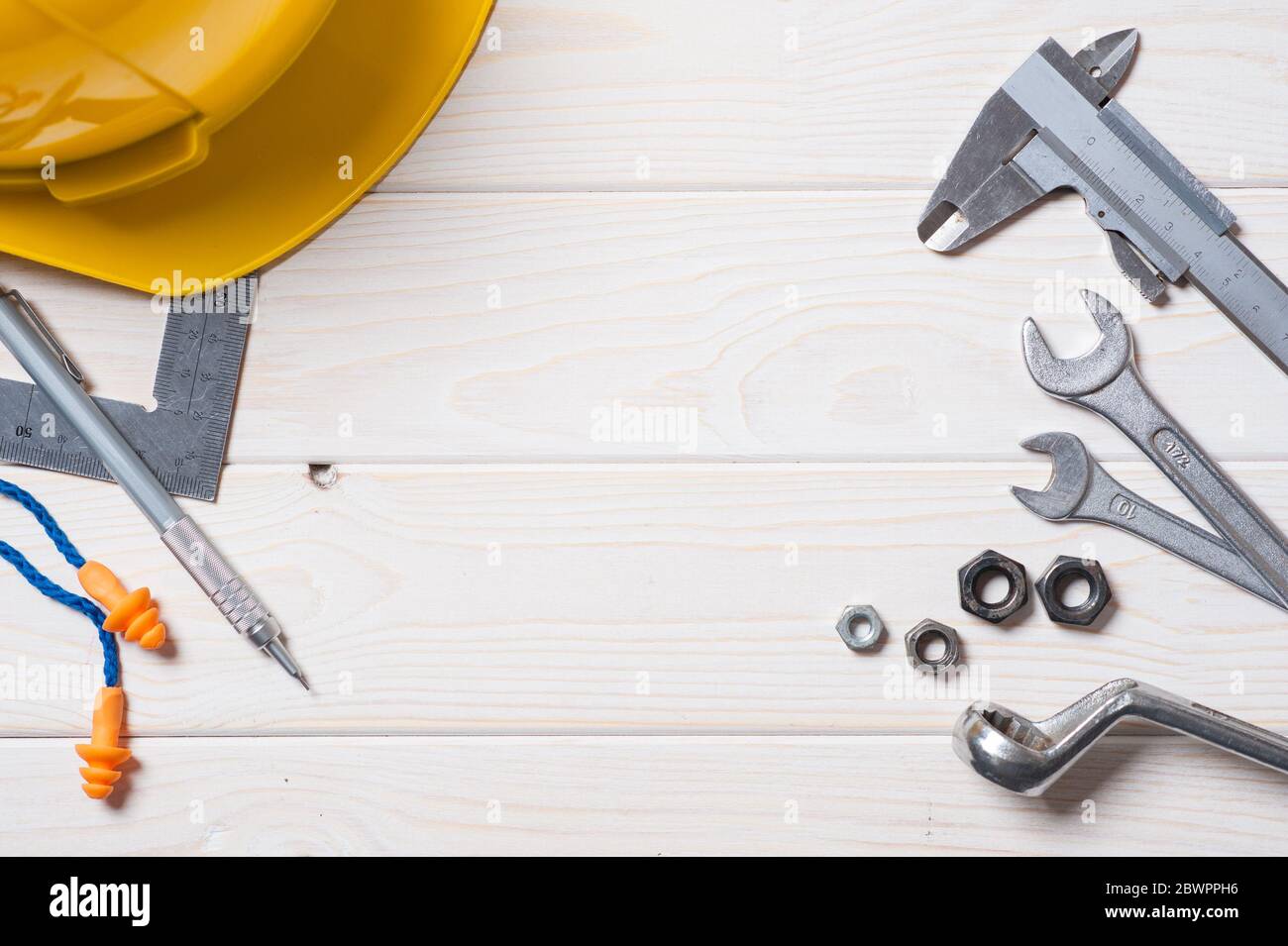 flat lay of industrial objects on white wooden plank with space for ...