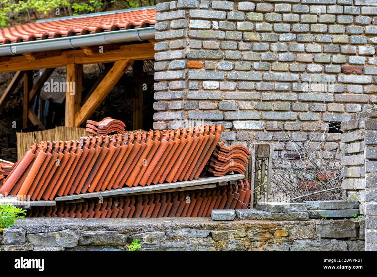 Shelves with new tiles are standing against a brick wall, prepared for