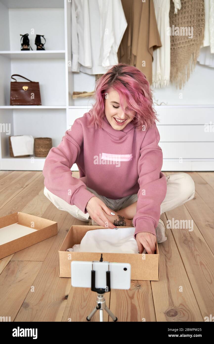 Hipster gen z teen girl fashion blogger pink hair record unboxing vlog vertical. Stock Photo