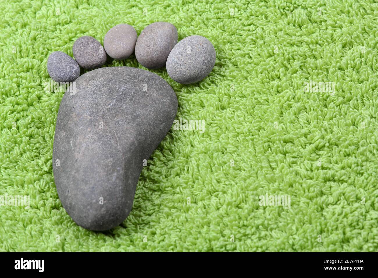 Foot symbol on green terry towel Stock Photo