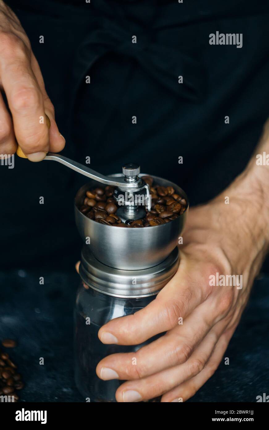Grinding coffee beans barista before making a coffee drink. Freshly