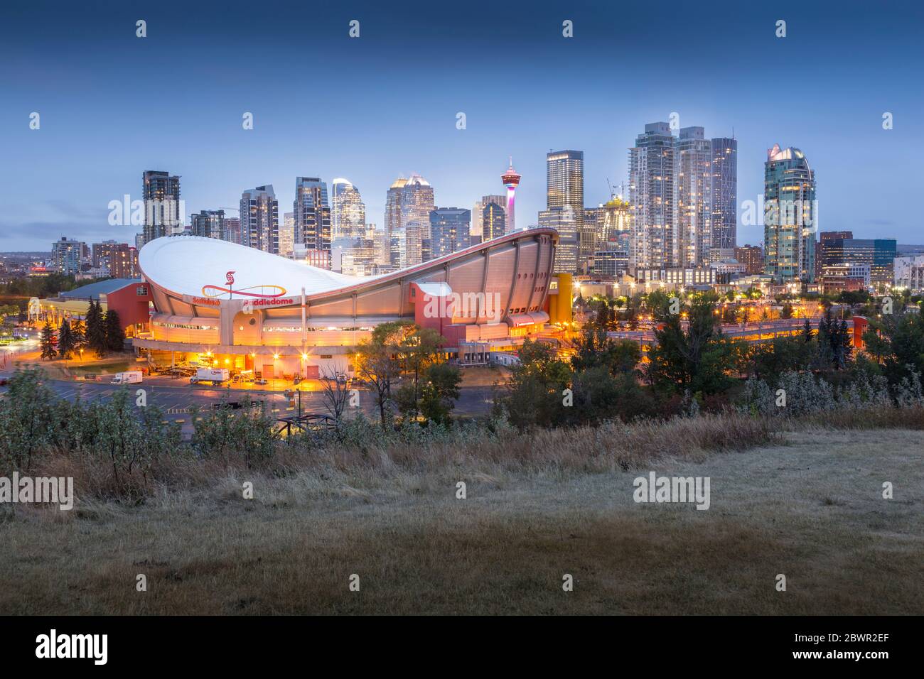 View of the Saddledome and Downtown skyline from Scottsman Hill at dusk