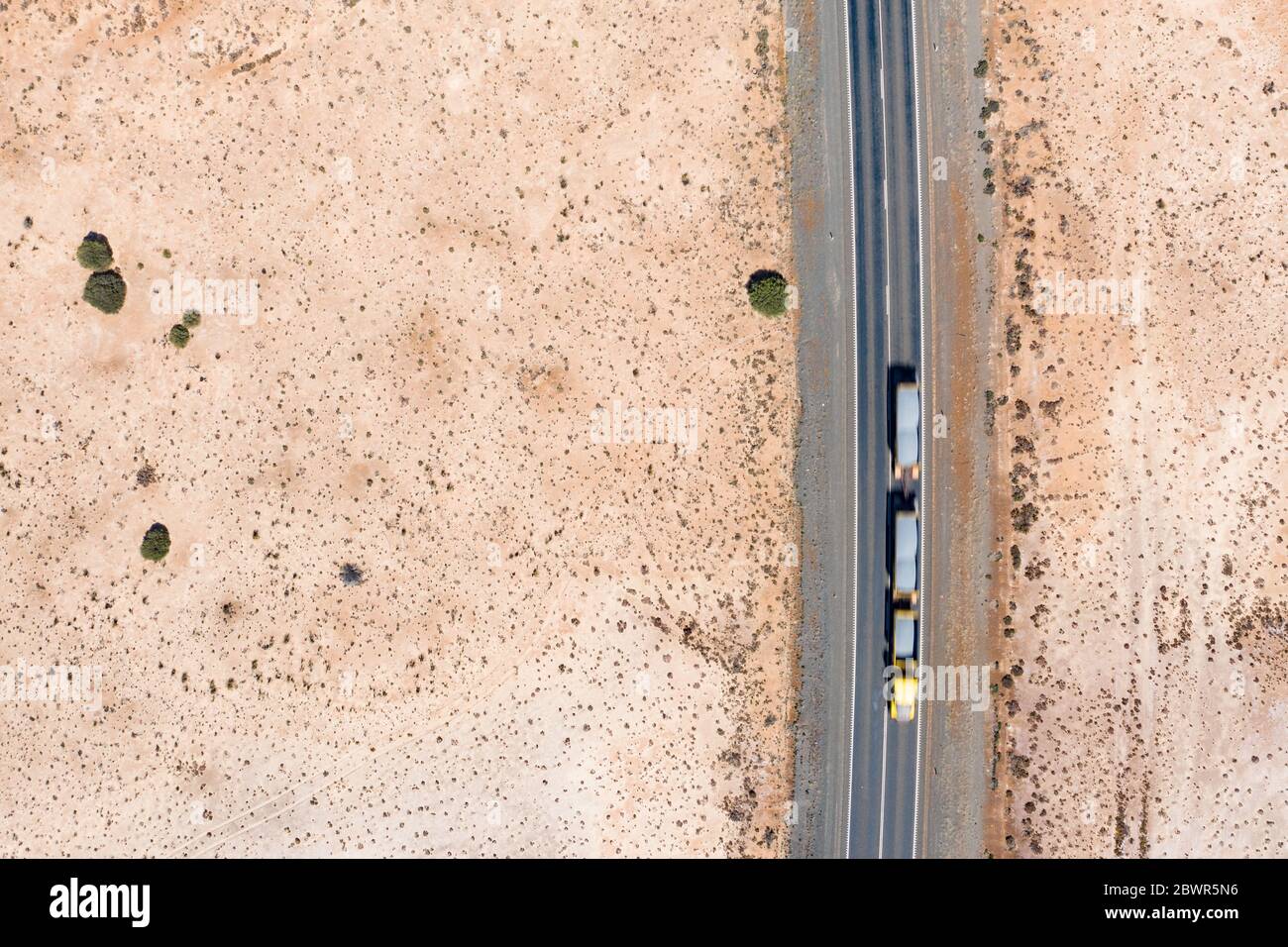 Aerial views of the road over the dry pink lake on the Coolgardie-Esperance highyway just north of Norseman in Western Australia Stock Photo