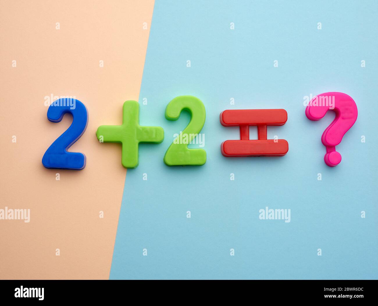 math example two plus two equals of colorful plastic numbers, view from