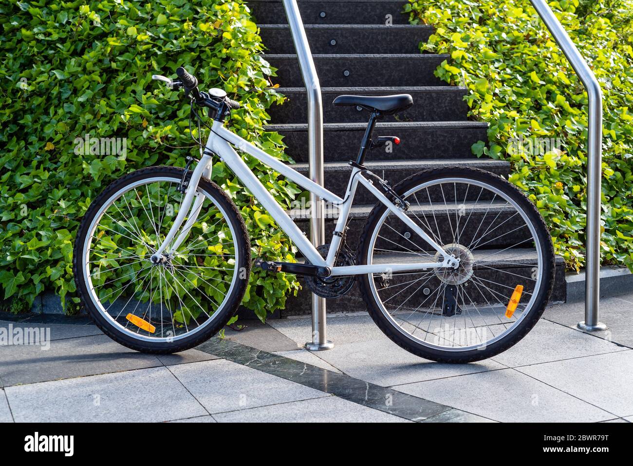 White Urban Bicycle Parked in the Street. Stock Photo