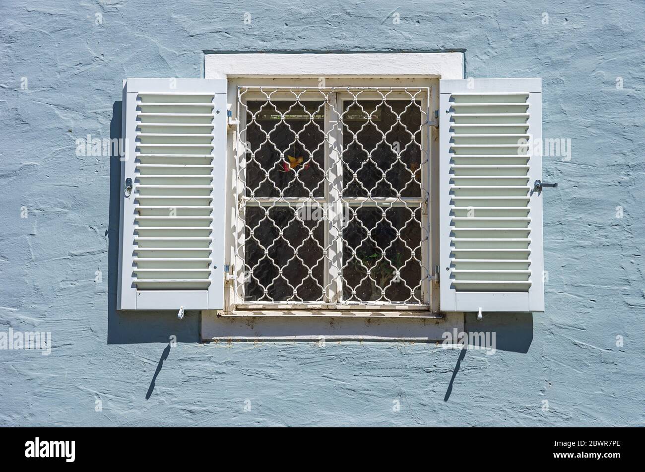 Barred window with shutters in the Old Town of Lindau in Lake Constance