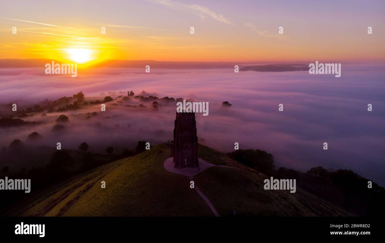 Early morning sunrise over Glastonbury Tor and the misty fields, Somerset. Stock Photo