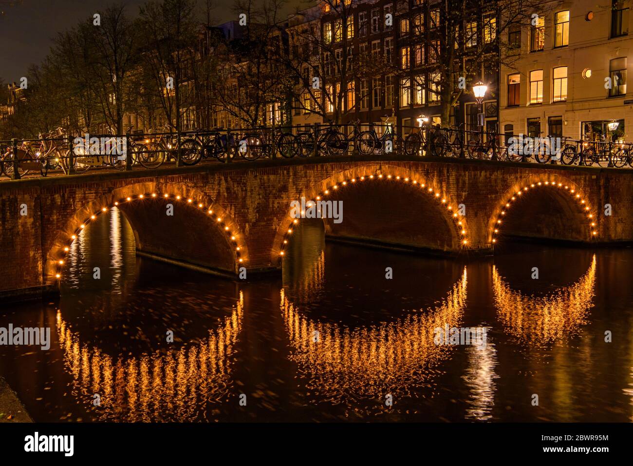 Canal reflections at night, Amsterdam, North Holland, Netherlands. Stock Photo