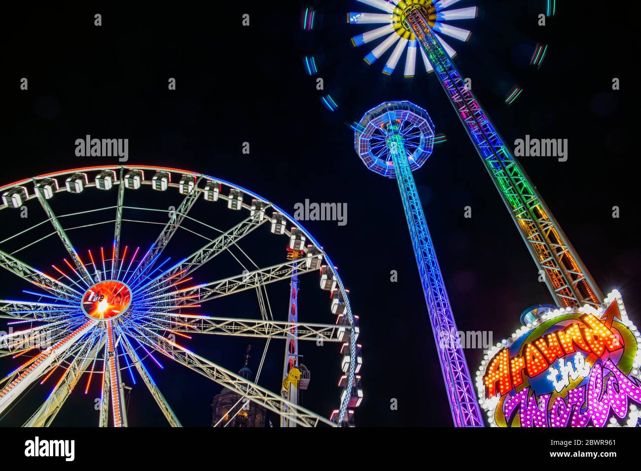 Dam Square Fun Fair Carnival rides at night, Amsterdam, North Holland, Netherlands. Stock Photo