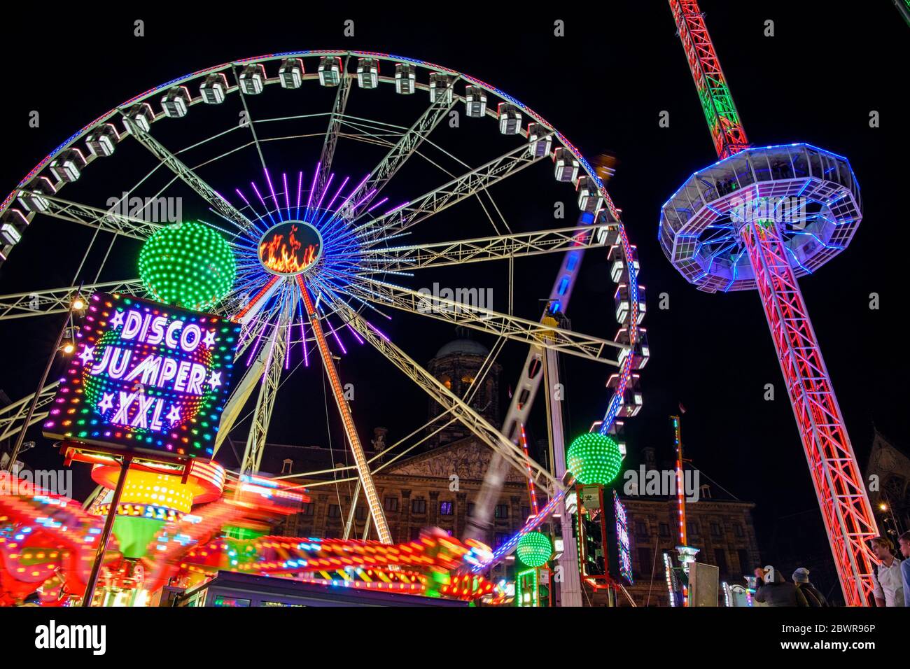 Dam Square Fun Fair Carnival rides at night, Amsterdam, North Holland, Netherlands. Stock Photo