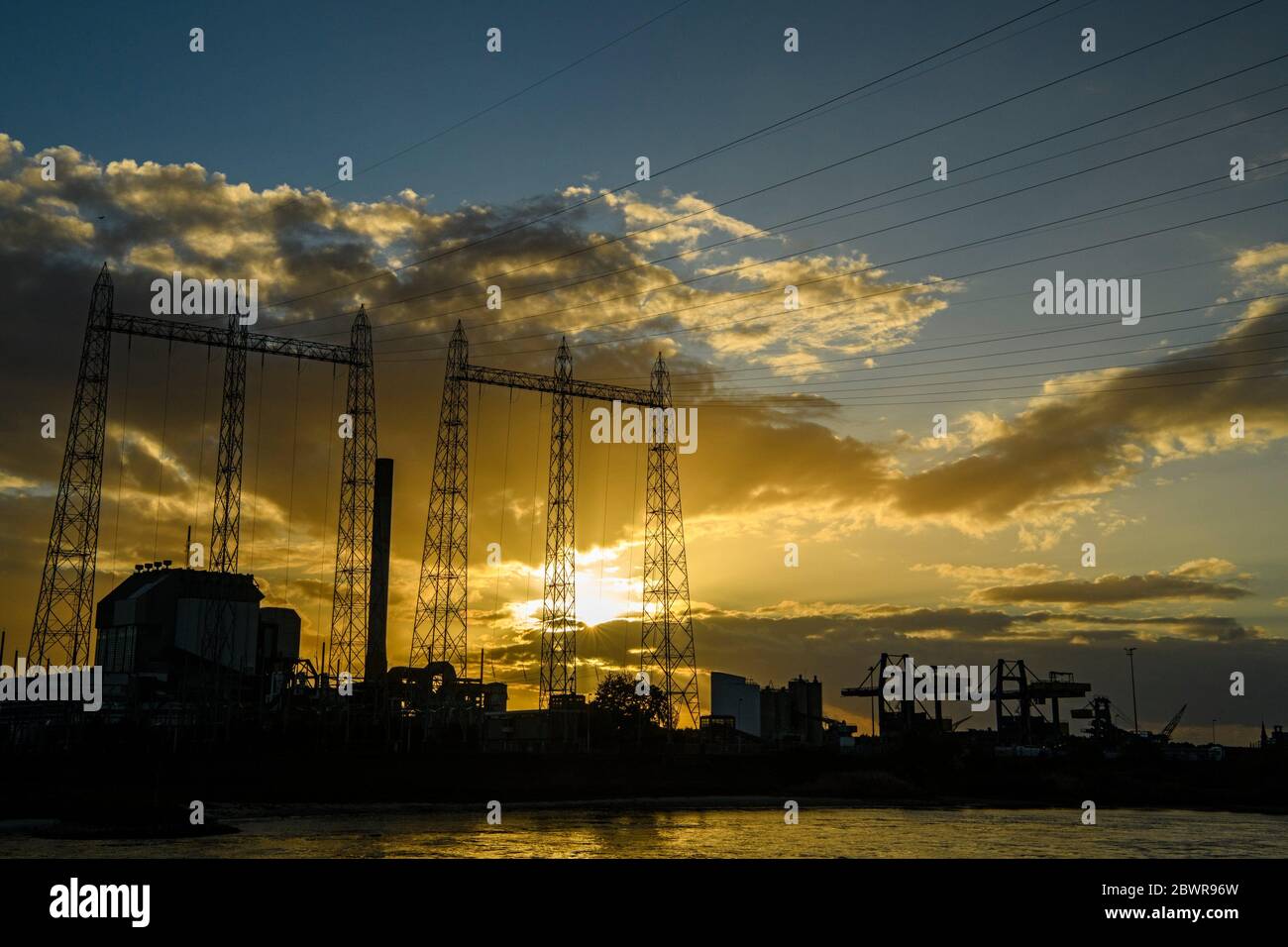 Sunset along the industrial sector of the Waal River, Nijmegen, Gelderland, Netherlands. Stock Photo