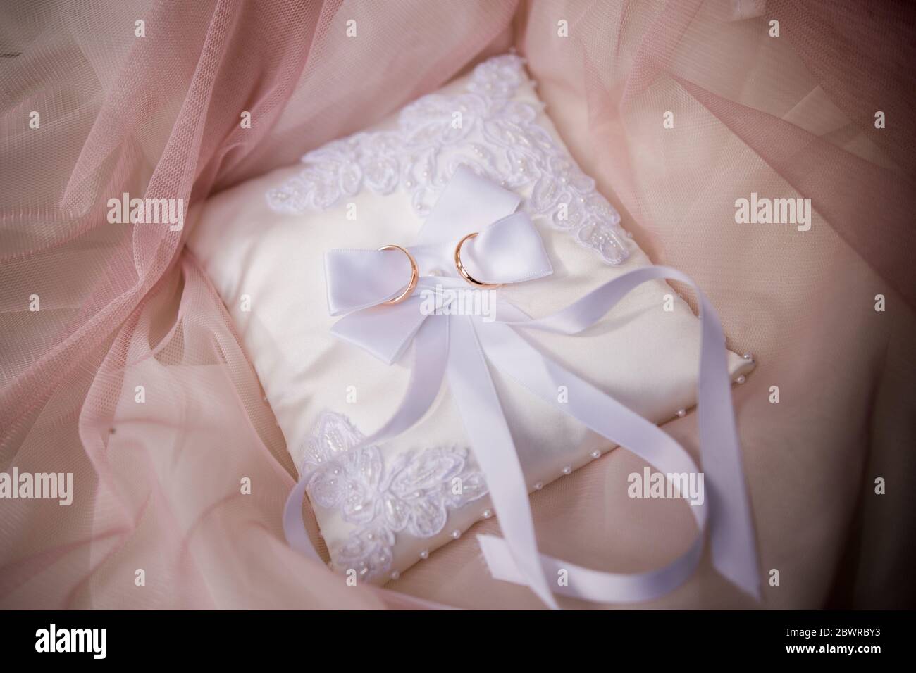 wedding gold rings on small pillow Stock Photo - Alamy