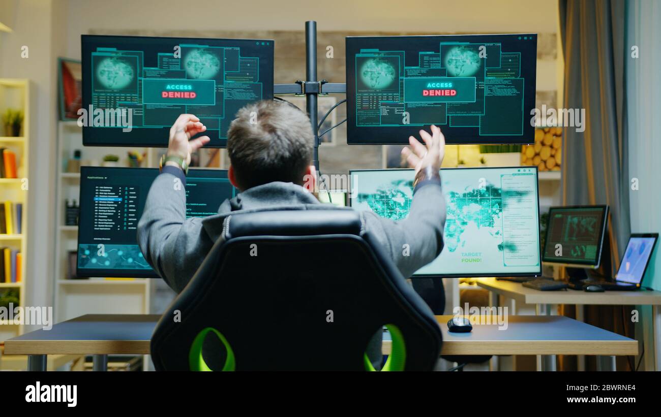 Back view of male hacker get access denied while doing a cyber crime ...