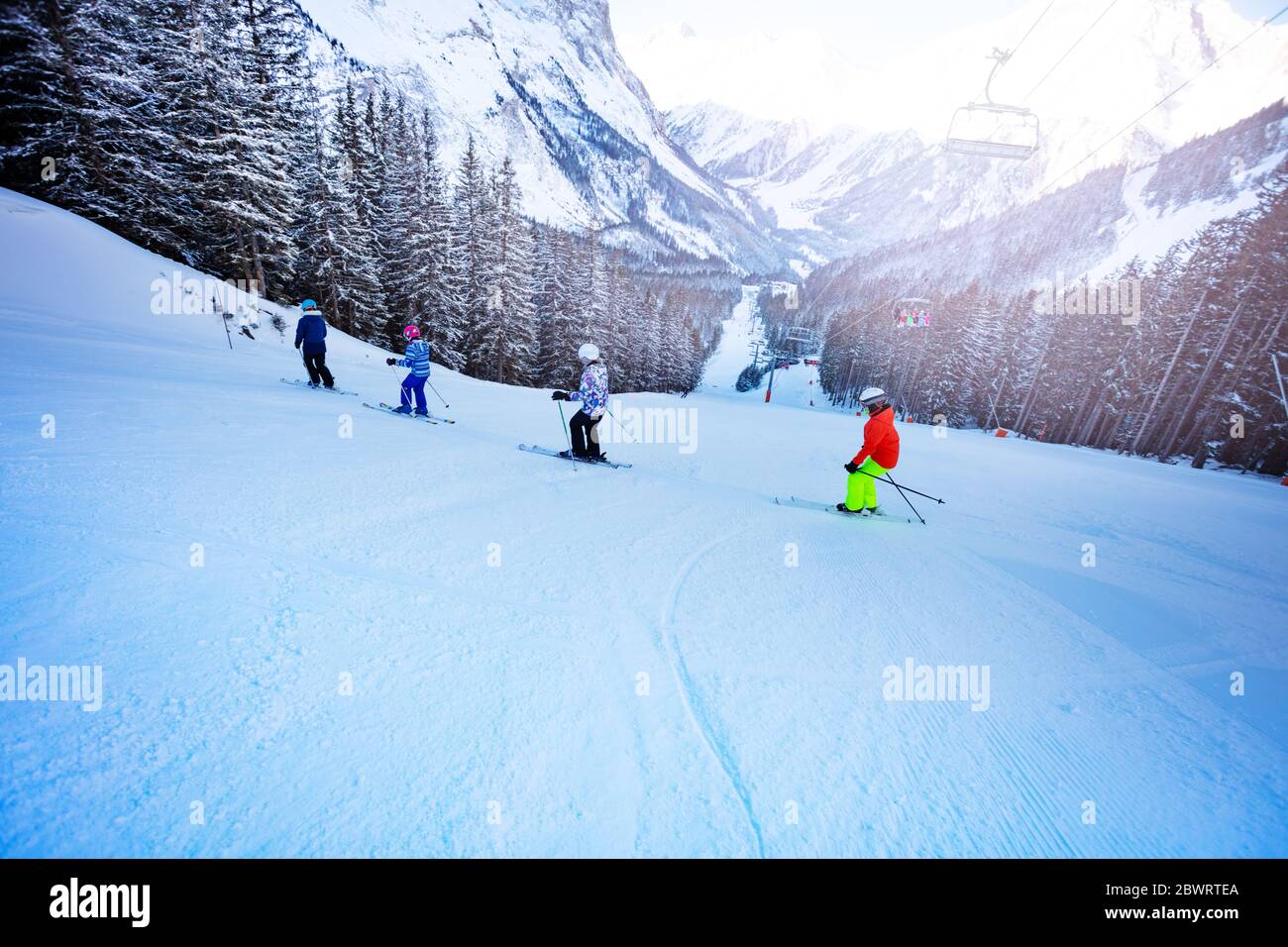 Ski School For Kids Group Of Children Ride Down The Slope One After Another With Mountains On Background Stock Photo Alamy
