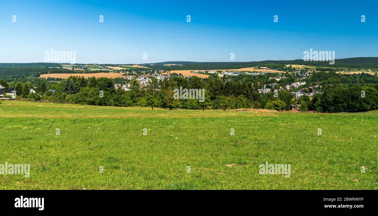 Markneukirchen town with beautiful hilly surrounding from meadow near Bismarcksaule view tower in Germany Stock Photo