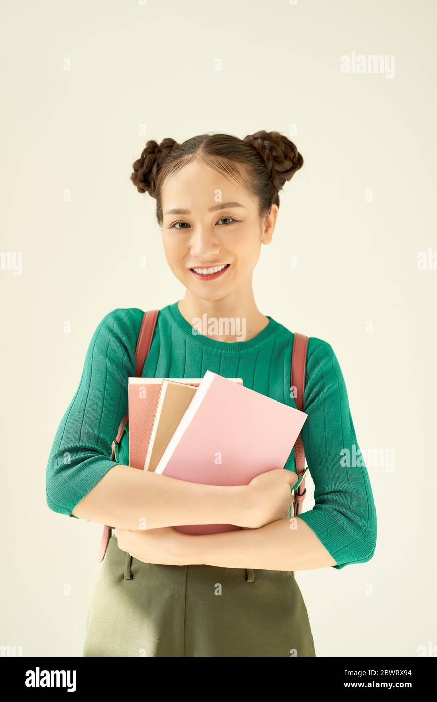 Portrait of a gorgeous young student girl holding exercise books Stock ...
