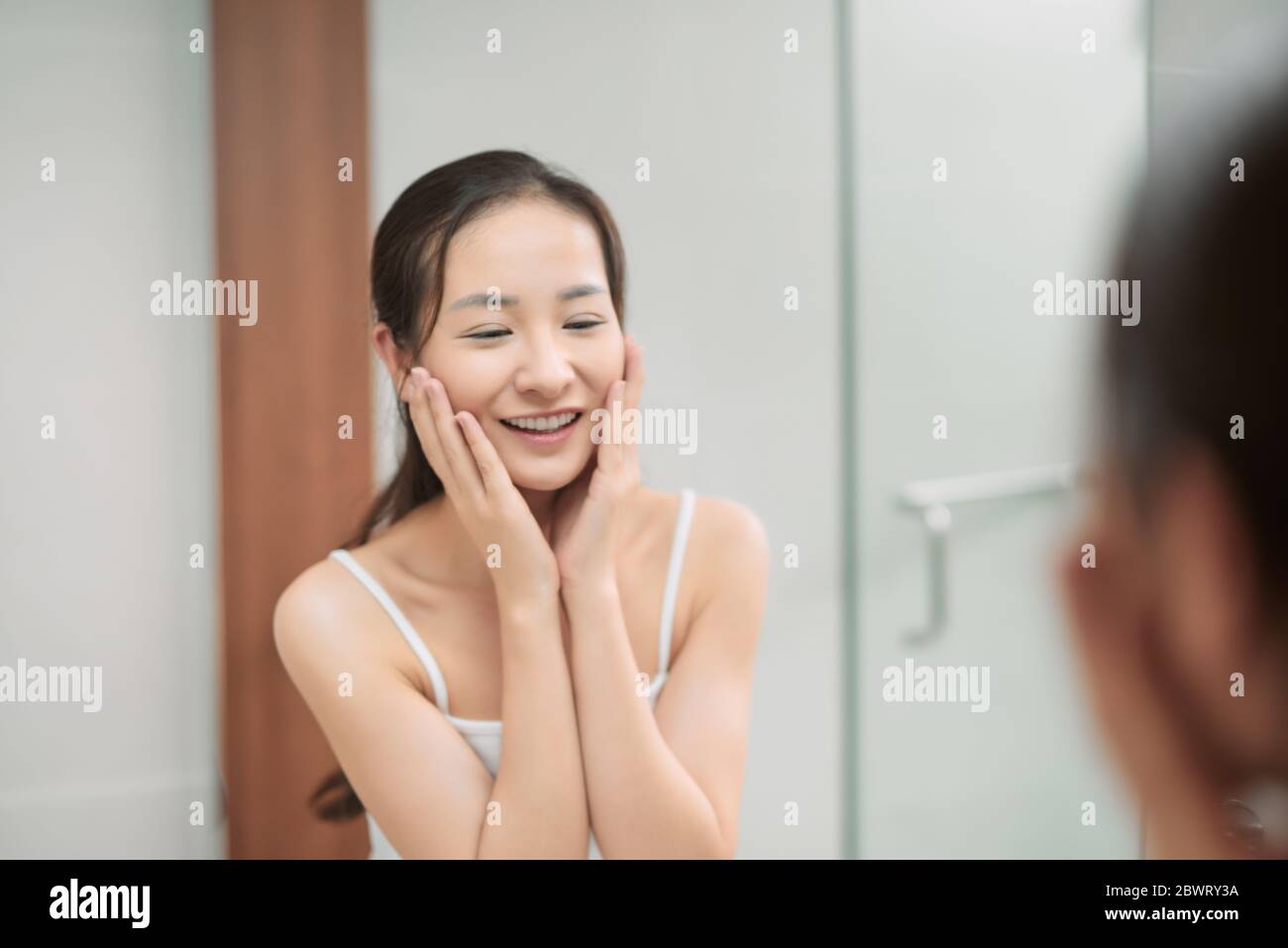 Beauty skin care. Young beautiful teenage girl touching her face before ...