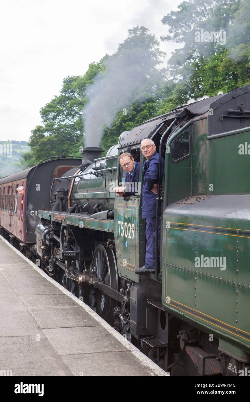 The driver and fireman of locomotive 75029 - Green Knight - waiting for the signal to depart from Grosmont on the North York Moors Railway Stock Photo