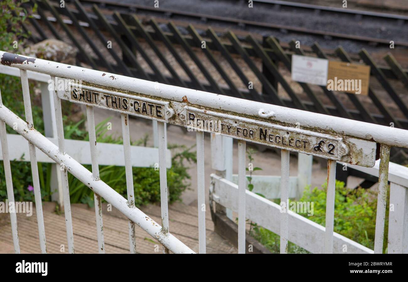 Shut this Gate warning sign on a white gate at Goathland on the North York Moors Railway - penalty for neglect £2 Stock Photo