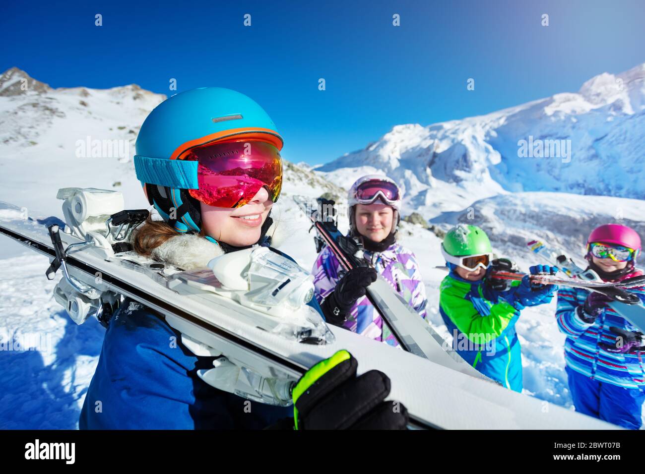 Cute girl skier skiing with family on mountain Stock Photo - Alamy